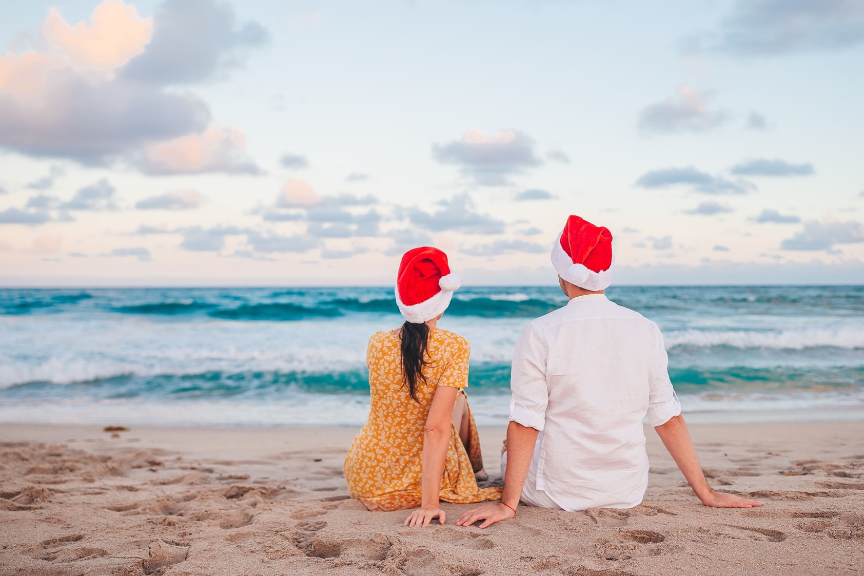 happy couple santa hats christmas